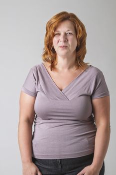 forty something woman with red hair trying her best to contain a laugh