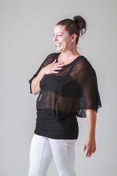 thirty something woman, wearing a transparent shirt, with surprise expression