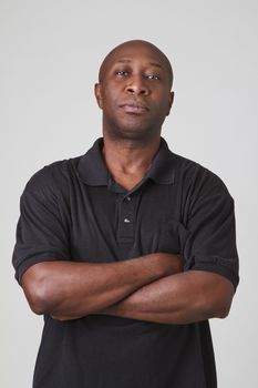 bald black man with his arm cross