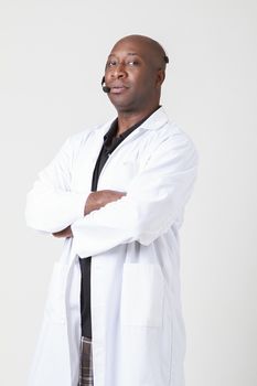 Forty year old black man, wearing a lab coat with telephone headset on his head