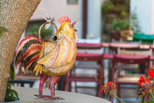 Metallic Chicken on a table locking chair