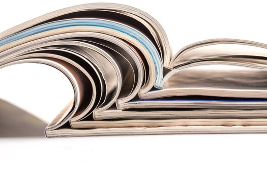 Stack of magazines on white background with reflection