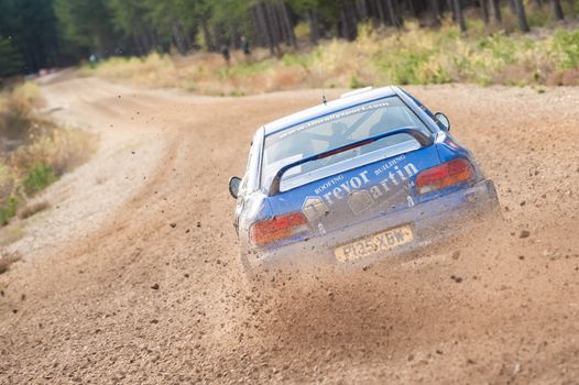 Bramshill Forest, UK - November 3, 2012: Driver Trevor Martin kicking up dust in a Subaru Impreza on the Warren stage of the MSA Tempest Rally in Bramshill Forest, UK