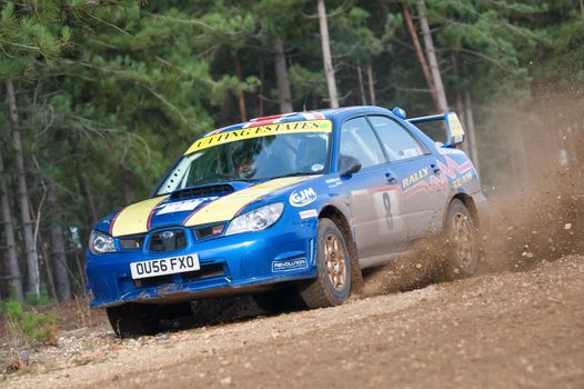 Bramshill Forest, UK - November 3, 2012: Driver Wug Utting kicking up dust in a Subaru Impreza on the Warren stage of the MSA Tempest Rally in Bramshill Forest, UK