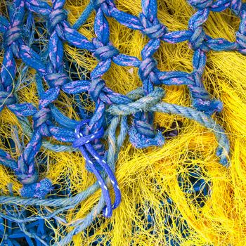 Abstract background with a pile of fishing nets ready to be cast overboard for a new days fishing