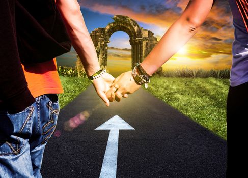 View of lovers couple holding hands on the road