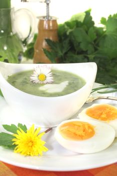 green herb soup with eggs and daisy