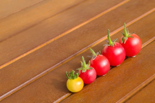 Photo shows a detail of the colourful tomatoes on a table.