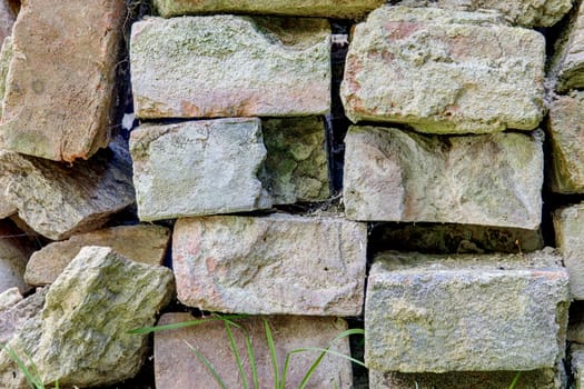 Photo shows closeup details of block of old bricks.