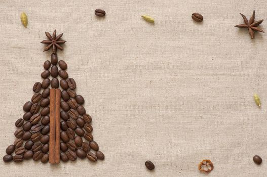 Christmas tree made of cinnamon sticks and coffee on linen background