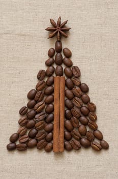 Christmas tree made of cinnamon sticks and coffee on linen background