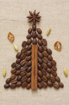 Christmas tree made of cinnamon sticks and coffee on linen background