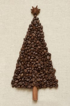 Christmas tree made of cinnamon sticks and coffee on linen background