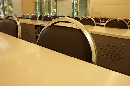 Classroom or seminar room consists of a long table and any chairs are placed.                               