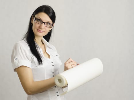 The girl in glasses is the roll of paper. Writes on a roll with a pencil. The architect. Designer.