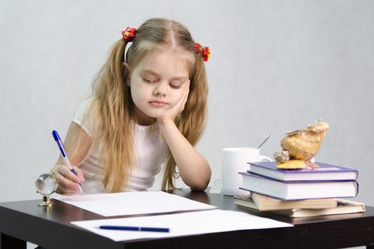girl sits at a table and wrote on a sheet of paper. There are tombs of books, sheets of paper, a pen, glass globe, with a glass of tea, sea shell. The image of the writer