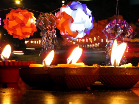 A view of the street full of skylanterns behind the traditionally lit lamps on the occassion of auspicious Diwali festival in India                               