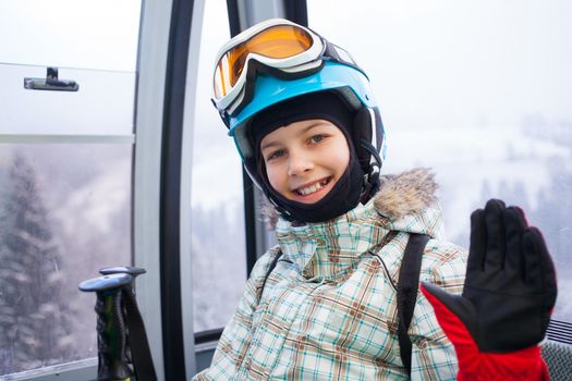 Ski lift, skiing, ski resort - happy skier girl on ski lift.