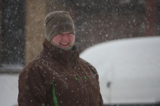 a girl wearing a hat enjoying the wintry snow