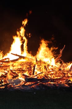 fire at night, orange flames on a black background