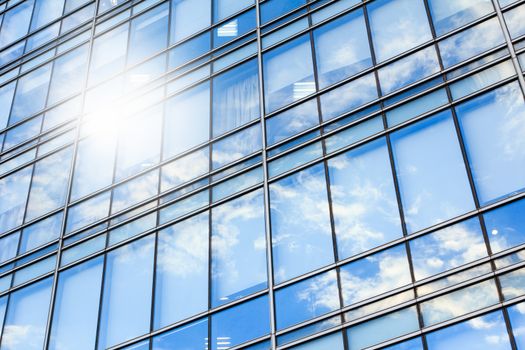 glass wall of office building,with reflection of clouds