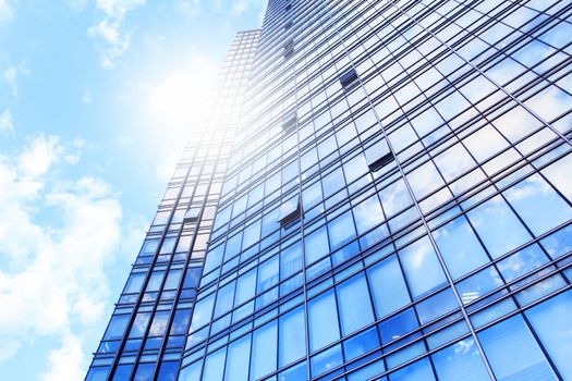 glass wall of office building,with reflection of clouds