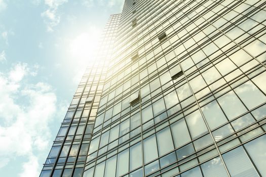glass wall of office building,with reflection of clouds