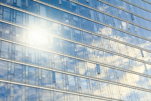 glass wall of office building,with reflection of clouds