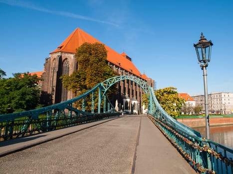 Tumski Bridge in Wroc�aw with a view of St. Mary's Church (Poland)