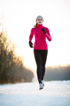 Winter running - Young woman running outdoors on a cold winter day