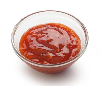 Red chinese spicy sauce in a transparent gravy boat