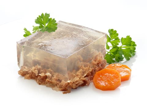 Isolated piece of beef aspic with green fresh parsley and orange carrot