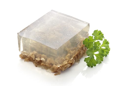 Isolated piece of beef aspic with green fresh parsley