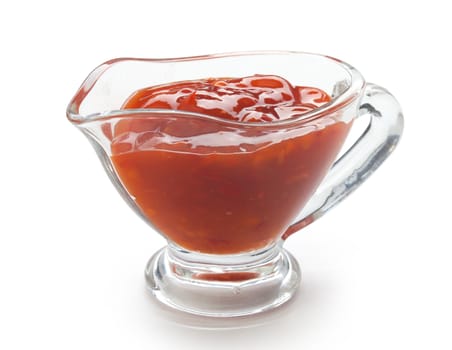 Red chinese spicy sauce in a transparent gravy boat