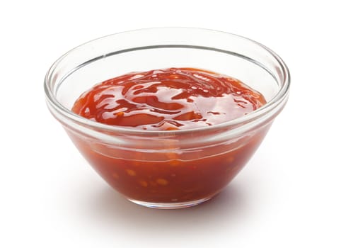 Red chinese spicy sauce in a transparent gravy boat