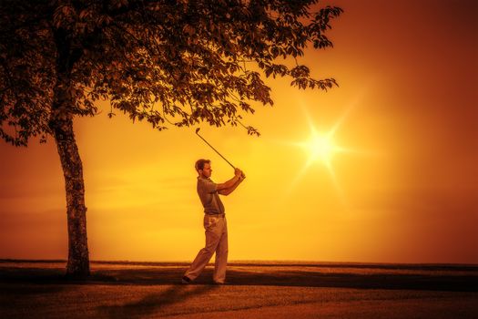An image of a young male golf player at sunset
