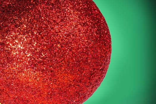 Abstract macro picture of a christmas ball with green background