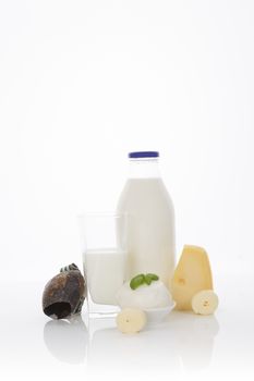 Traditional dairy products. Milk glass bottle, cheese, cottage cheese and curd isolated on white background. Healthy eating. 