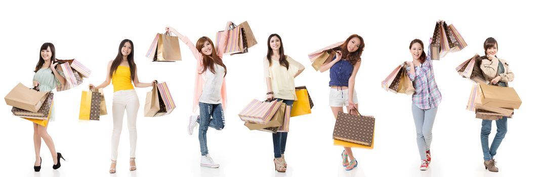 Attractive Asian women shopping and holding bags, full length portrait isolated on white background.