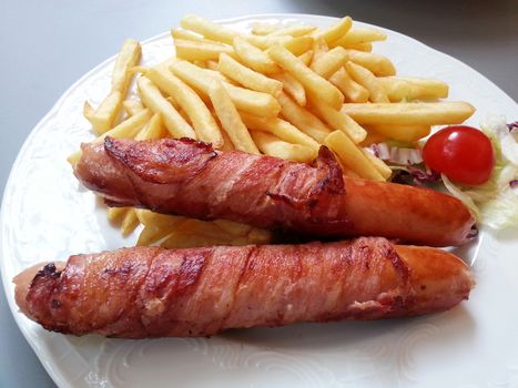 A dish of sausage with French fried in Vienna Austria.