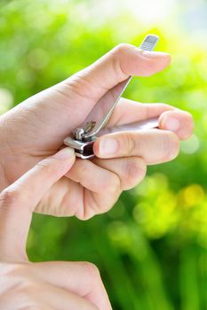 hand manicure with nail clipper Close up