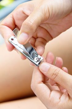 hand manicure with nail clipper