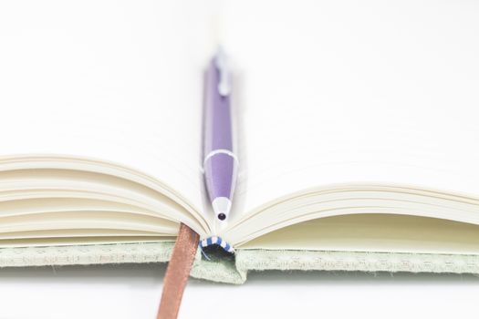 Closeup opened notebook and pen on white background, stock photo