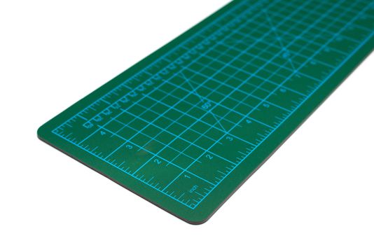 green cutting mat on a white background