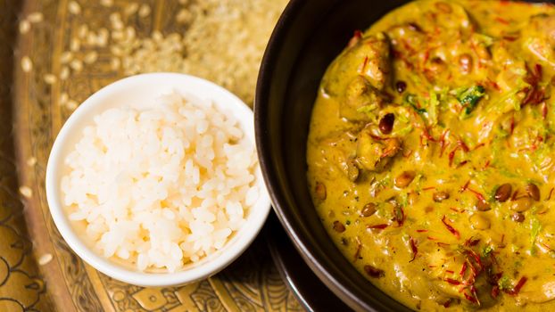 Chicken curry with rice and parsley in a bowl