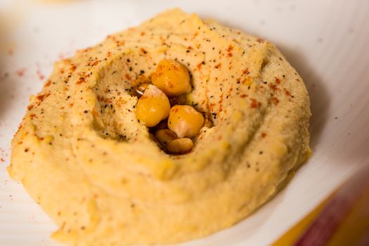 A bowl of creamy hummus with olive oil