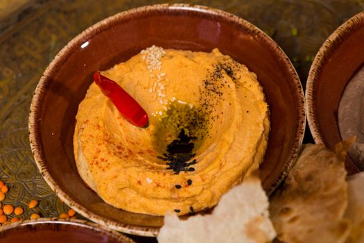 A bowl of creamy hummus with olive oil