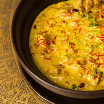 Chicken curry with rice and parsley in a bowl