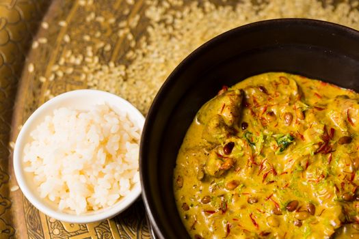 Chicken curry with rice and parsley in a bowl