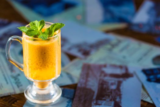 seabuckthorn tea in a glass cup decorated with mint leaves 